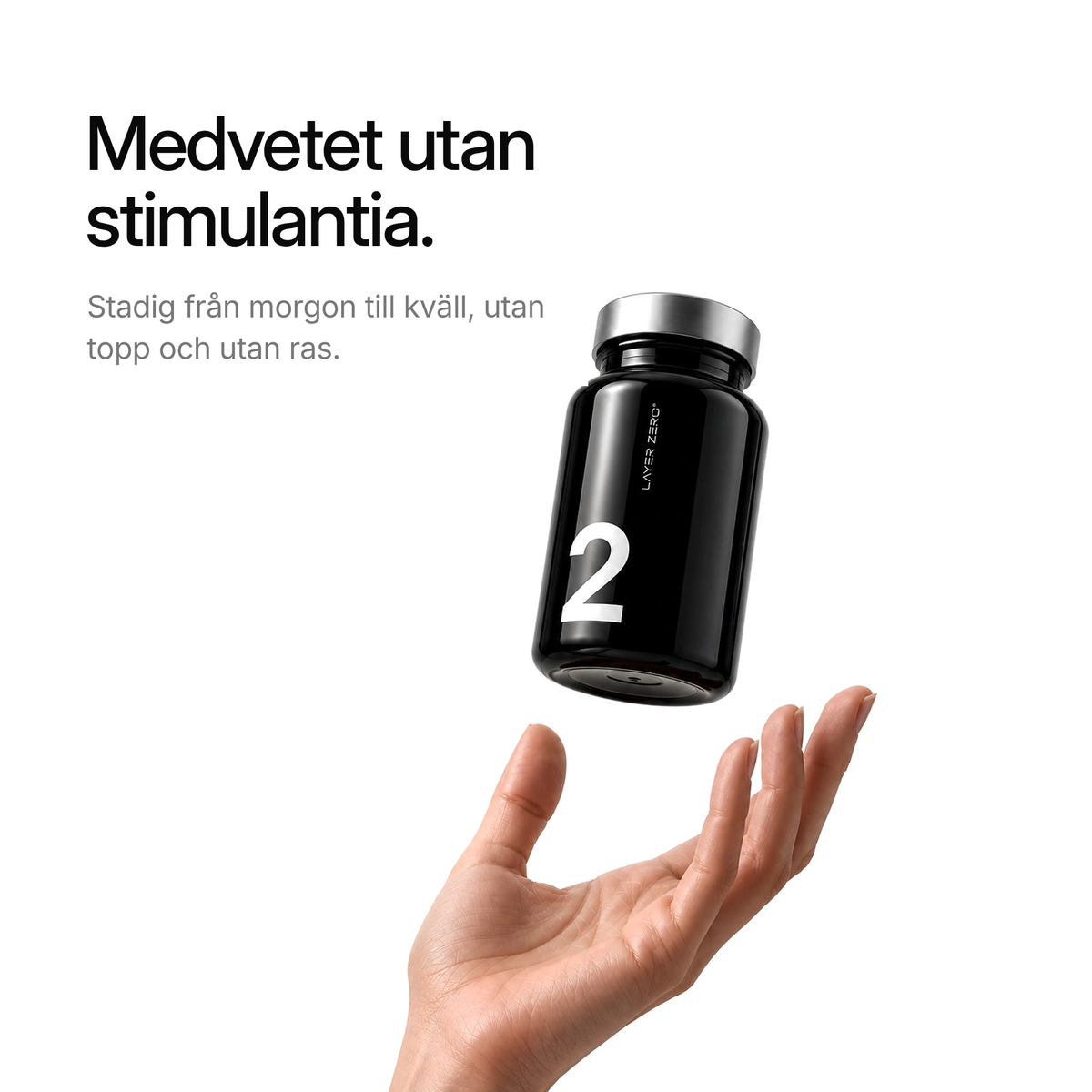 Burken LAYER TWO svävar ovanför en hand. Medvetet utan stimulantia